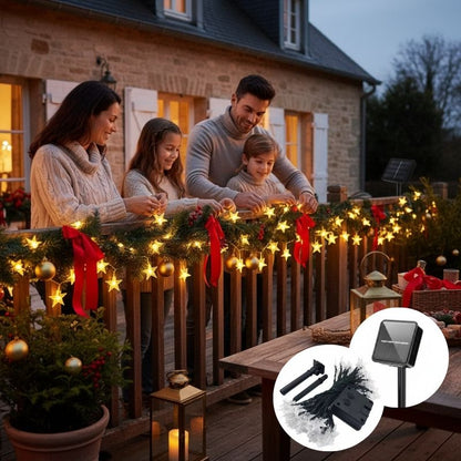 famille installe guirlande exterieur noel solaire étoiles rampe terrasse