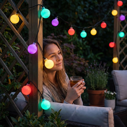 femme détente jardin guirlande exterieur solaire petits globes multicolores